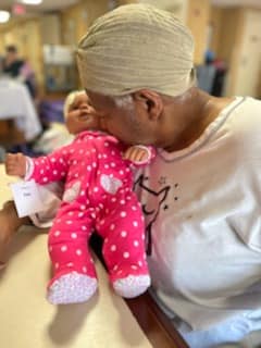 Woman kissing pink baby