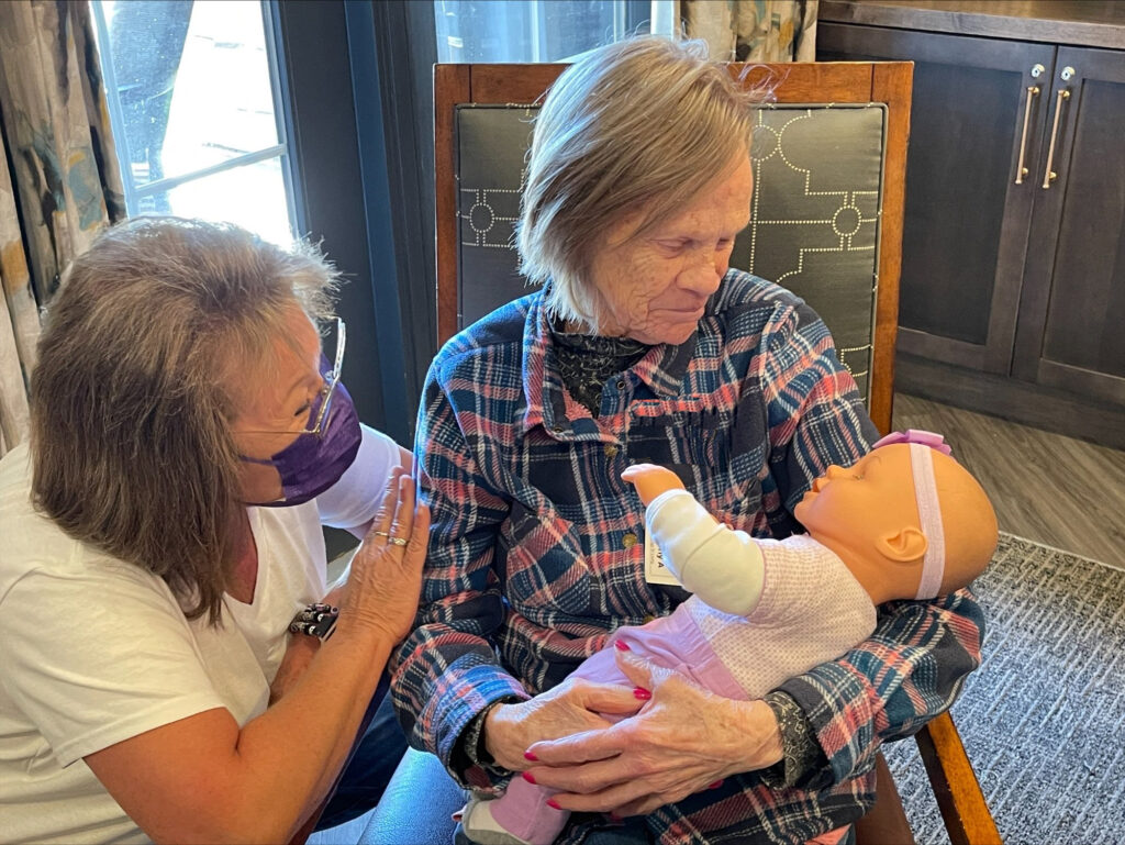 Woman looking at baby doll